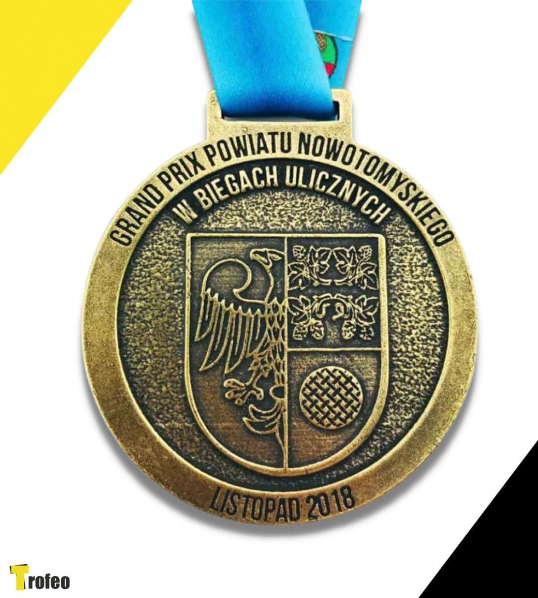 Odlewany złoty medal z herbem Nowego Tomyśla